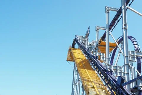 .Roller coaster ride design elements against the blue sky... Stock Photos