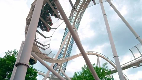 Roller coaster ride at Gardaland Park with thrill-seekers enjoying Stock Footage 335999060