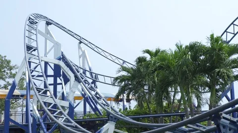 Roller coaster ride working in amusement park. Moving extreme attraction Stock Footage 106488543