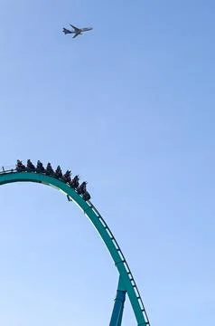 Roller Coaster Riders Experience Thrill at Amusement Park Stock Photos
