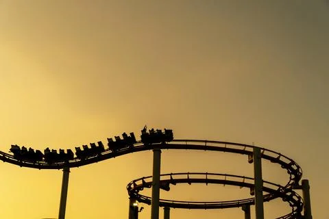 Roller Coaster Silhouette Glows at Sunset Along California Coast Stock Photos