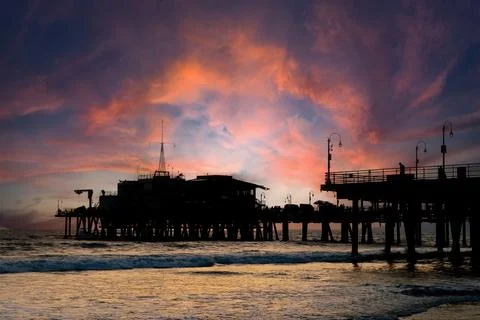 Roller Coaster Silhouette Glows at Sunset Along California Coast Stock Photos