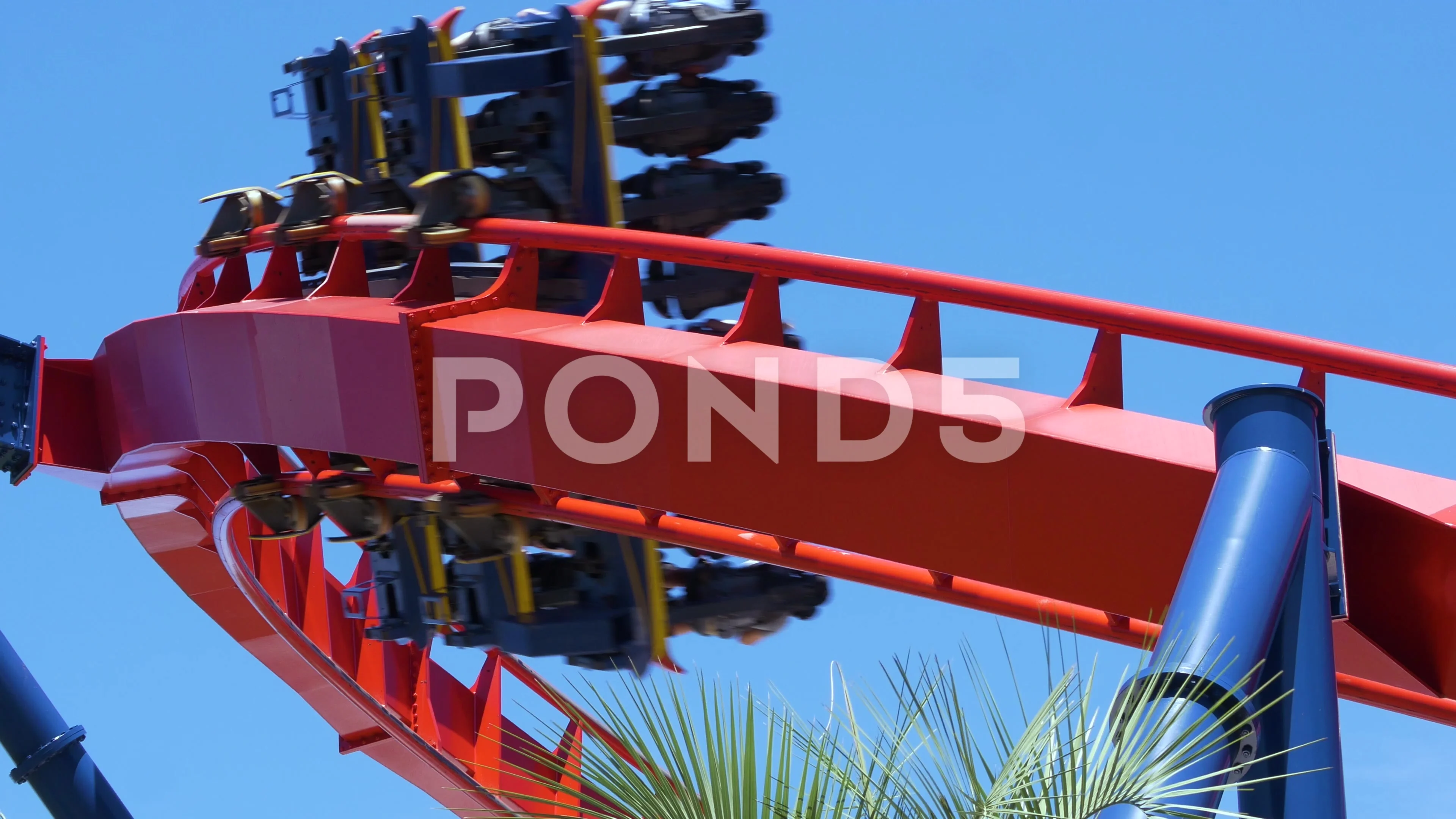 Roller coaster speeds through frame on sharp turn