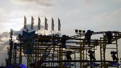 Roller coaster at sunset Fairground Octoberfest Munich Stock Footage 89960228