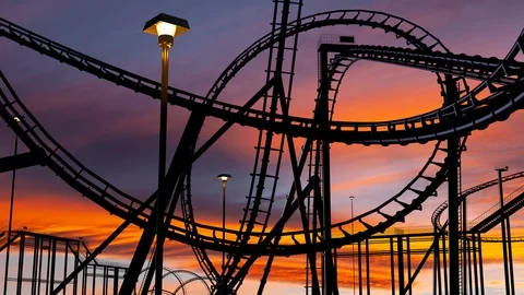 Roller coaster thrill ride at amusement park during sunset with car Stock Footage 102639039