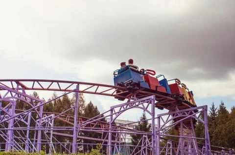 Roller coaster track blue sky at amusement park Stock Photos