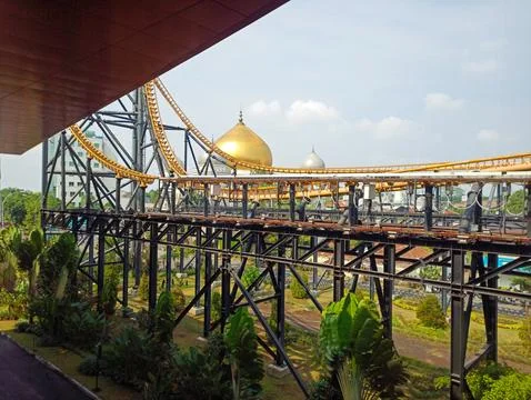 Roller-coaster track with colored mosque domes in the background Stock Photos