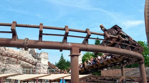 Roller coaster train attraction at Gardaland climbs steep track Stock Footage 336388203