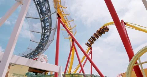 Roller Coaster Train Descending Yellow Track at Amusement Park Stock Photos
