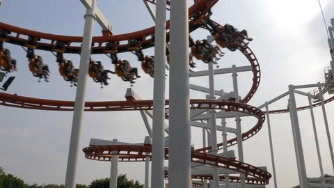 Roller coaster train following the circuit that leads down in a spiral, Video stock 101371368