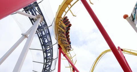 Roller coaster train speeding through loop at amusement park Stock Photos