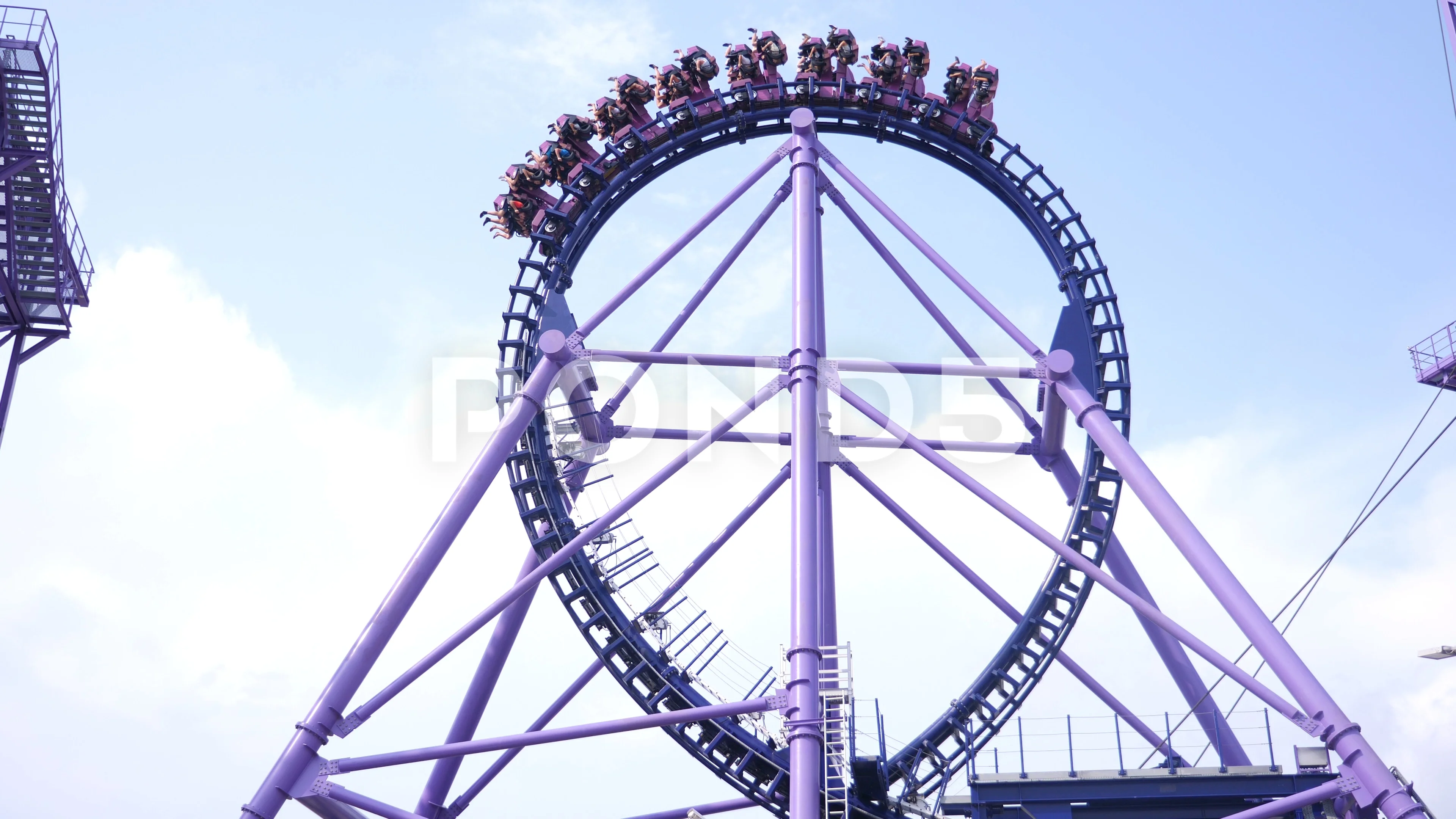 roller coaster a trolley with people riding on the loops of a roller coaster