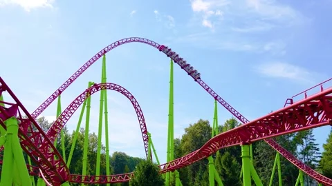 Roller coaster, trolleys up and down turn and the passing train Stock Footage 295945179