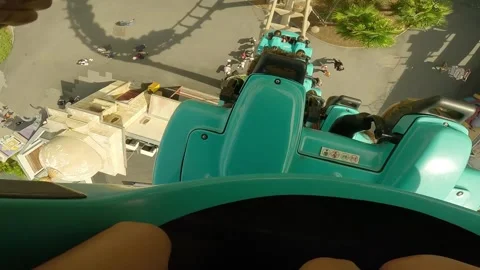 A roller coaster with two large loupes with the bright sun in the daylight. Stock Footage 247134575