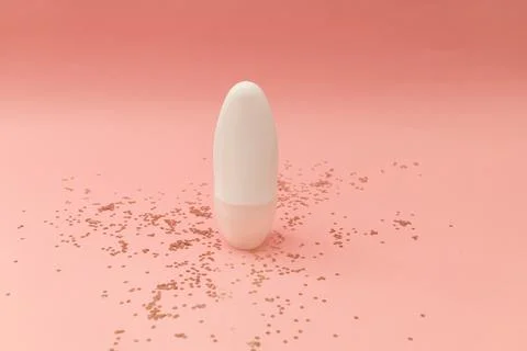 Roller deodorant in a white bottle on a pink background Stock Photos