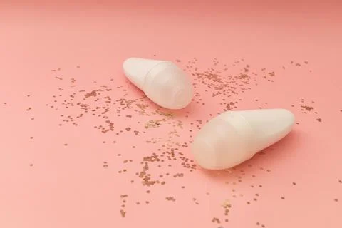 Roller deodorant in a white bottle on a pink background Stock Photos