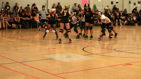 Roller Derby Action Between CVR and Battle Borne with Pushing and Falls Stock Footage 97561225