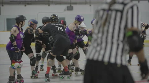 Roller derby game with referee in the foreground Stock Footage 232535650