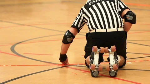 Roller Derby Referee Fixing Markings on Floor Stock Footage 97560830