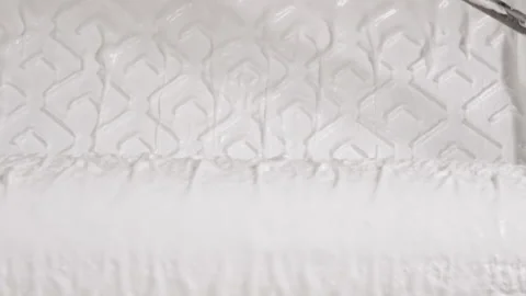 Roller is dipped in white paint poured into a pallet. A close-up of thick white Stock Footage 169052223
