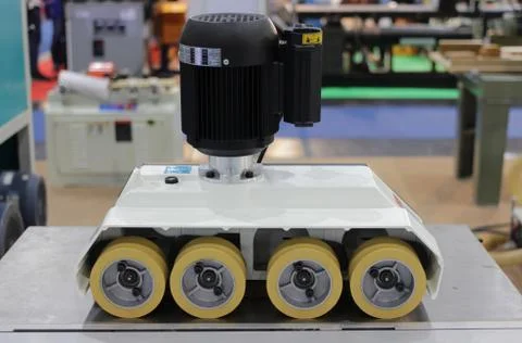 Roller feeder for automatic wood cutting industrial machine. Stock Photos