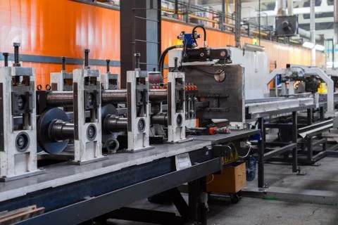 Roller forming machine. The interior of the plant producing a metal profile. Stock Photos