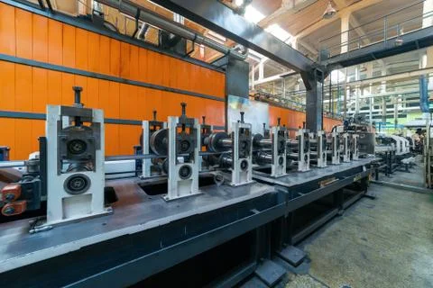 Roller forming machine. The interior of the plant producing a metal profile. Stock Photos