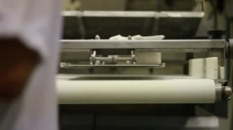 Roller machine flatens bread at end Stock Footage 9441802