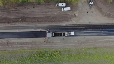 Roller machines make new asphalt roads. The asphalt paver squeezes hot asphalt. Stock Footage 130193627