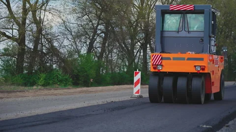 Roller machines make new asphalt roads. The asphalt paver squeezes hot asphalt. Stock Footage 130194614