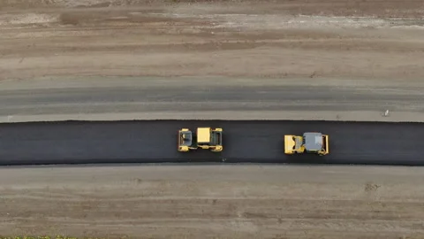 Roller machines make new asphalt roads. The asphalt paver squeezes hot asphalt. Stock Footage 130199311