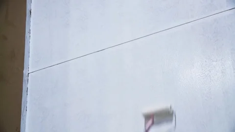Roller painting with white paint Stock Footage 128929200