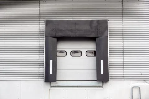 Roller shutter door and concrete floor inside factory building for industrial Stock Photos