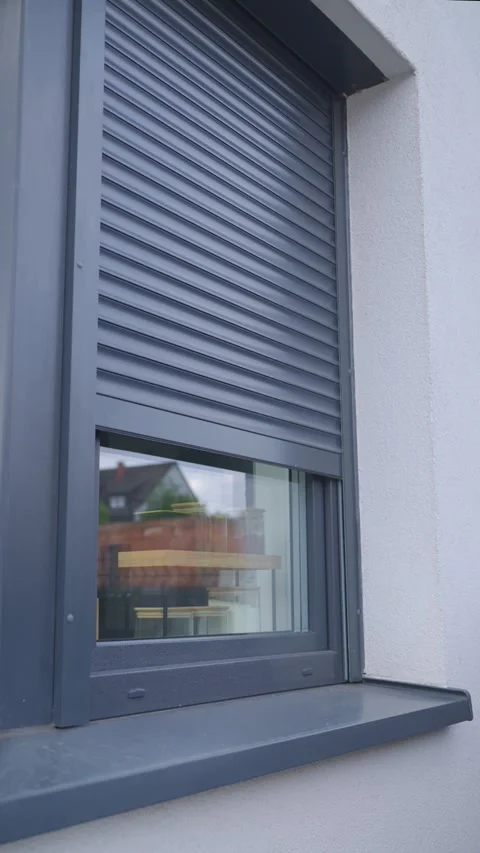 Roller shutter rises over house window, revealing storage jars inside 스톡 동영상 340854458