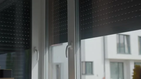 Roller shutters rise over kitchen windows, allowing more daylight into the room Stock Footage 340289274