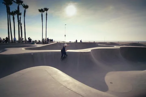 Roller Skater Gliding Through Venice Beach Skate Park at Sunset Stock Footage 322135954