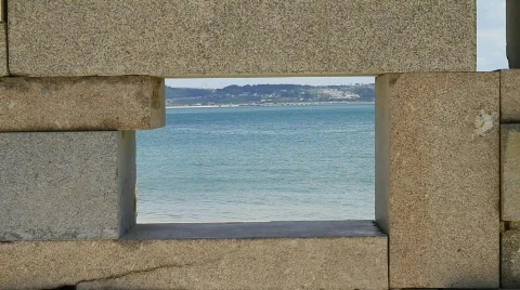 Roller-Skater Passing by the Beach, framed in a Very Small Stone Window 스톡 동영상 765523