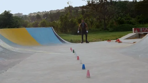 Roller skater rides slalom element with small cones in slow motion. Stock Footage 110852759