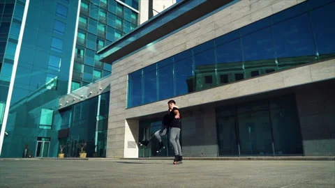 Roller skaters performing stunts in city Stock Footage 140971621