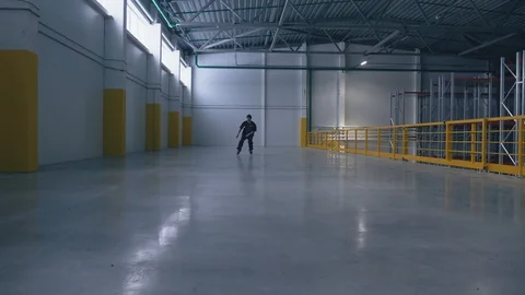 Roller skating guy does the trick at the logistic center and falls Video stock 104361712