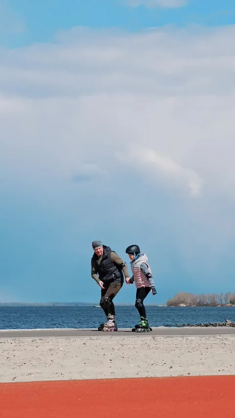 Roller skating outdoors. rollerblading outdoors. Father and teenage daughter are Stock Footage 317938021