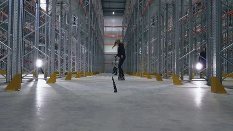 Roller skating stunts in the logistics center. Slalom tricks Stock Footage