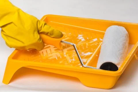 Roller in tray with paint Stock Photos