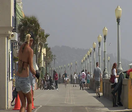 Rollerblader and Pedestrians on the Mission Beach Boardwalk Stock Footage 34742403