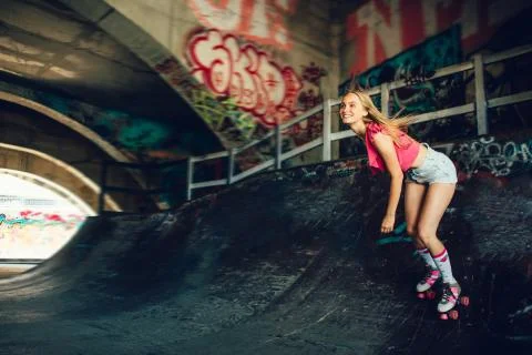 This rollerblaider likes to do riskful tricks. She is riding on rollers. Girl Photos