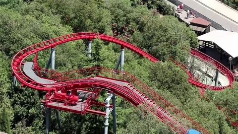 A rollercoaster in a park Stock Footage 69102215
