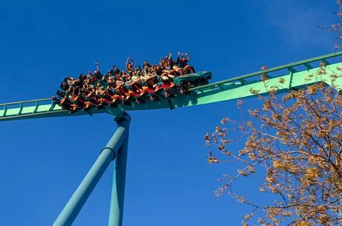 Rollercoaster Riders Experience Thrill at Amusement Park Stock Photos