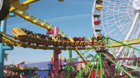 Rollercoaster screams towards camera and passes by at Santa Monica Pier Stock Footage 134057517