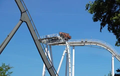 Rollercoaster track curving down . Blue sky background Stock Photos