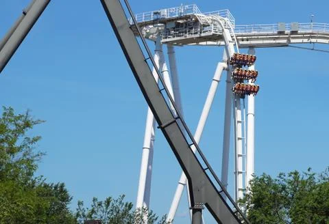 Rollercoaster track curving down . Blue sky background Stock Photos